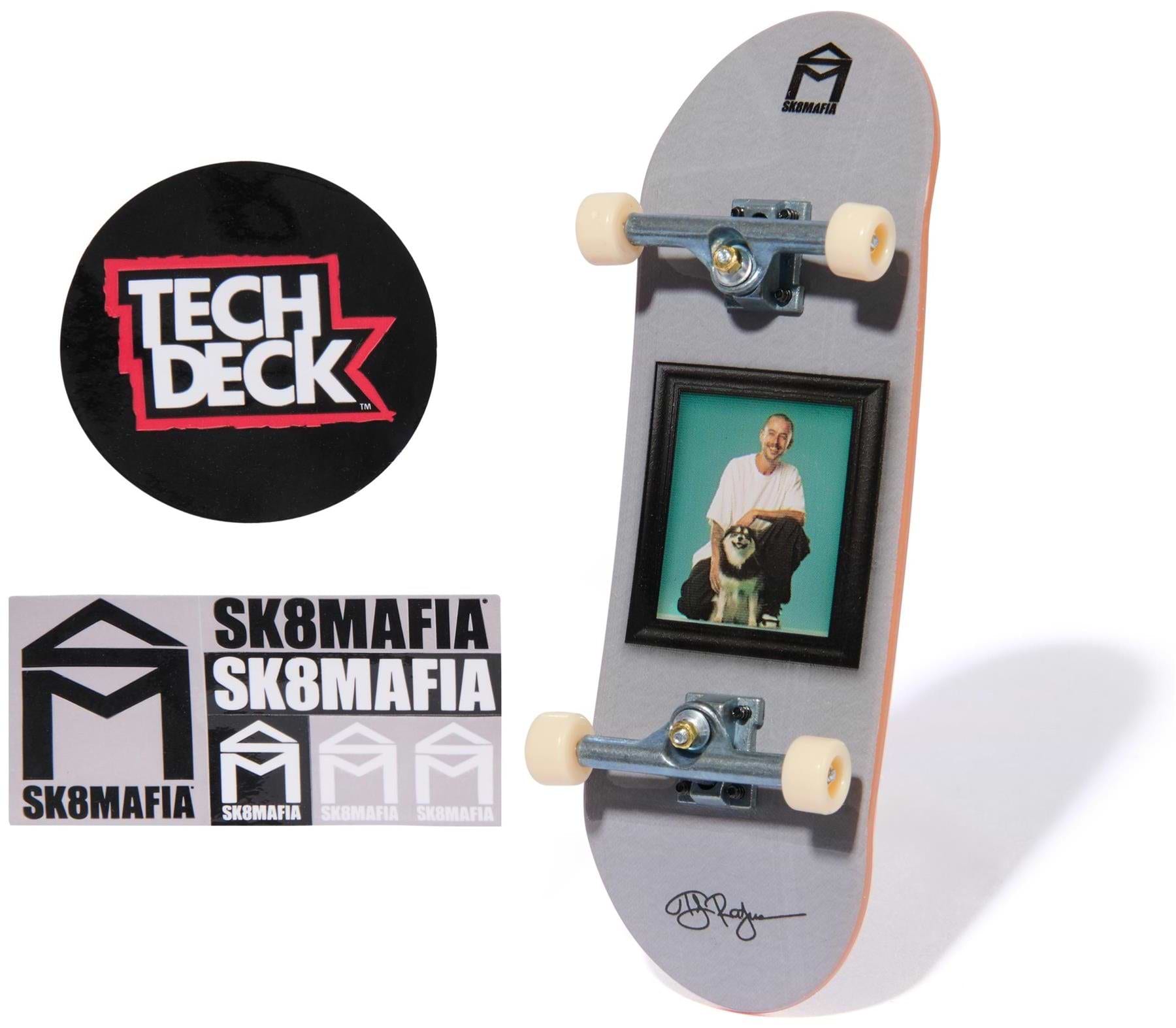 The Tech Deck 96mm M57 Fingerboard - SK8Mafia by Tech Deck features a photo of a man and dog on the deck, SK8MAFIA stickers, and a round Tech Deck logo sticker, all displayed on a white background—ideal for fingerboard fans.