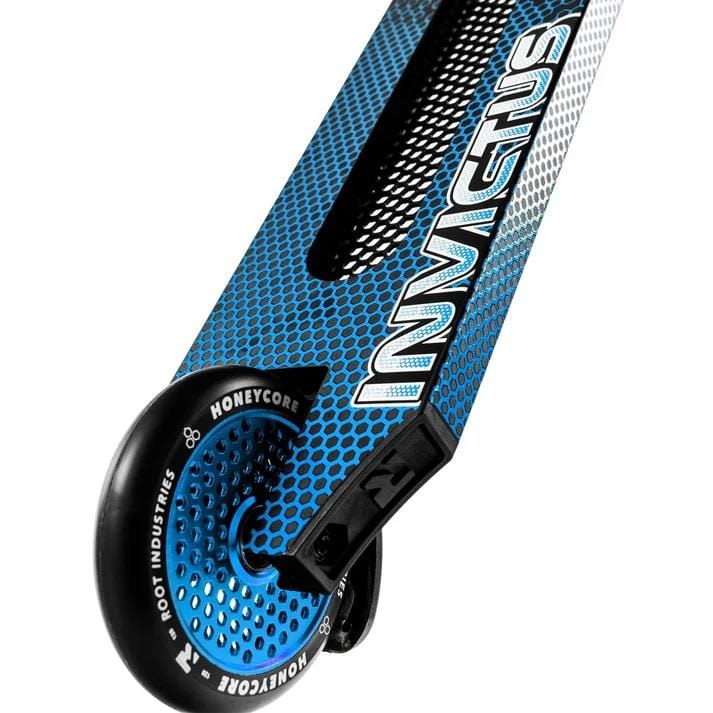 Close-up of the Root Industries Invictus V3 Complete Stunt Scooter - Burnt Blue, showing "INVICTUS" on the deck and a black Root Industries Honeycore wheel with circular cutouts.