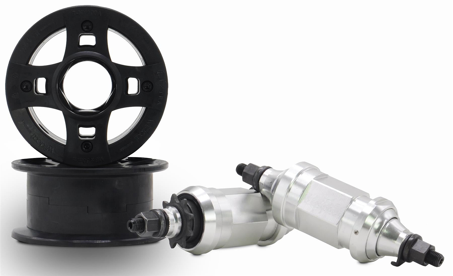 Two black plastic go-kart wheel rims are shown next to two silver kart wheel hubs with bolts on a white background—durable parts like those found on the Wildcat OG 3A Mini BMX Bike - Royal Red Bull by Wildcat. One hub leans at an angle against the other.