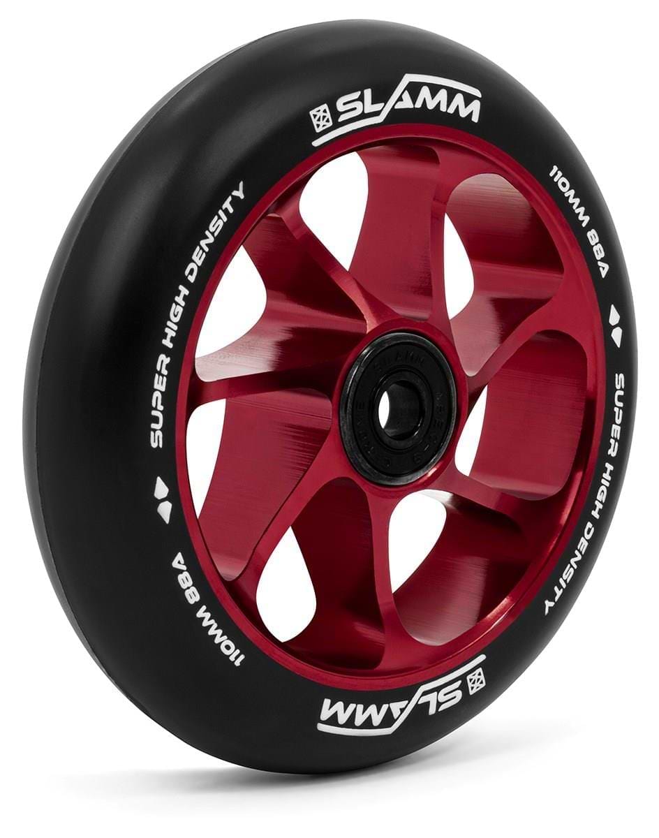 A detailed view of a red scooter wheel highlights the "SLAMM" and "SUPER HIGH DENSITY 110MM 88A" markings. This wheel, crafted with a premium-grade aluminum core and a high-rebound PU construction, features an elegant five-spoke design, emphasizing the performance-driven Slamm Team 110mm Stunt Scooter Wheel in red.