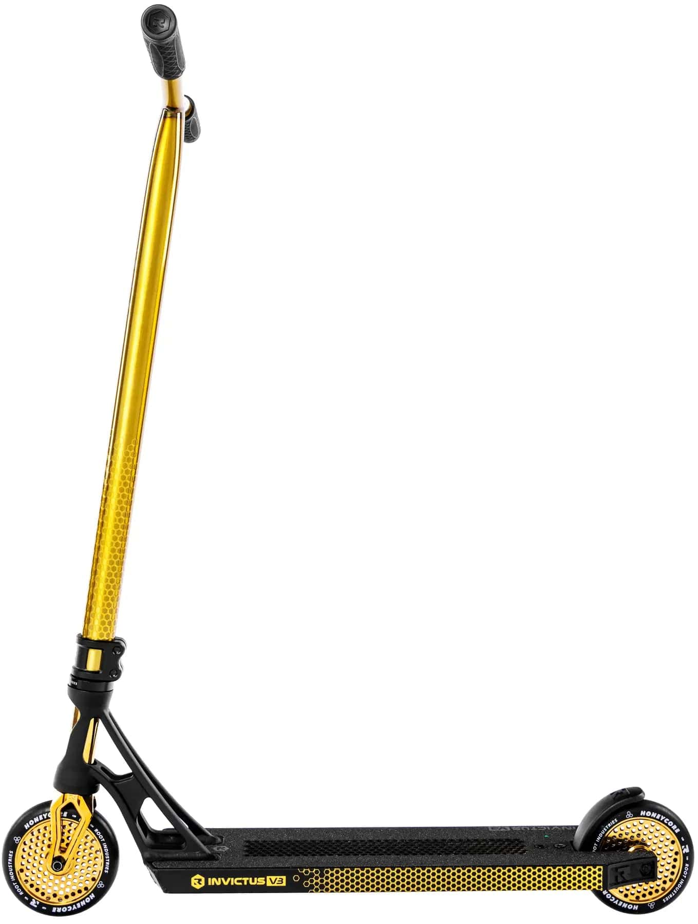 The Root Industries Invictus V3 Complete Stunt Scooter in Burnt Gold features a yellow and black design with a honeycomb deck pattern and Honeycore wheels, shown from the side against a white background.