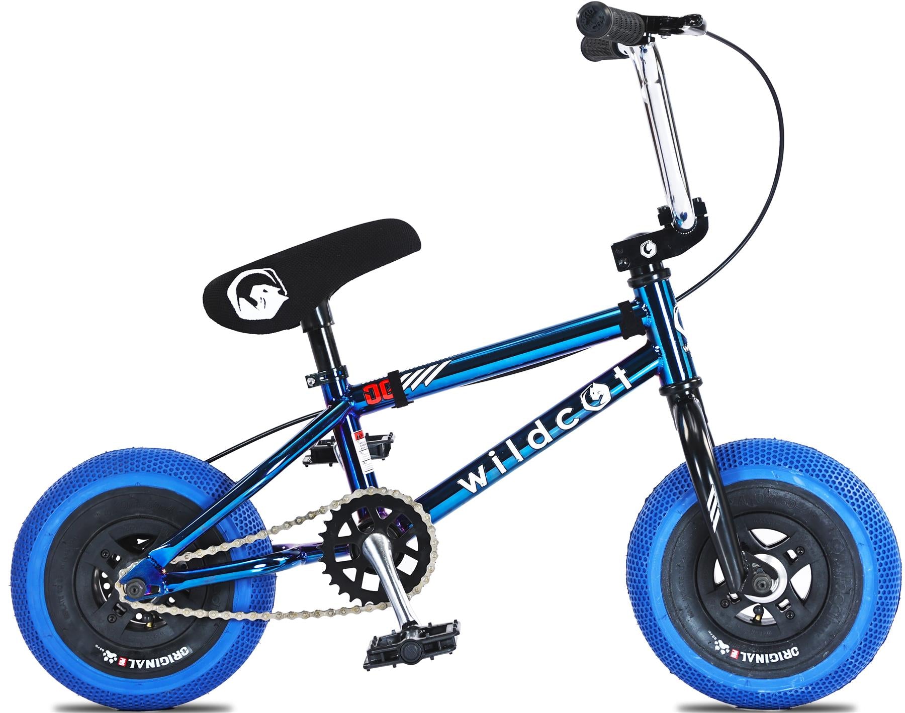 The Wildcat OG 3A Mini BMX Bike - Royal Blue features a blue and black frame, black seat, blue tires, CNC aluminium rims, visible pedals, chain, brake cables, and PRO Street 65PSI tyres. "Wildcat" is printed on the frame.