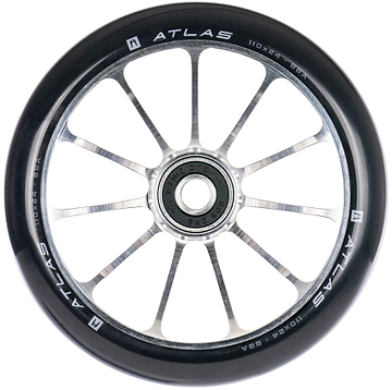 A close-up of the Ethic DTC Atlas 110mm Stunt Scooter Wheel - Raw shows its black and silver finish, ten metal spokes, central bearing, and white Ethic branding with size details on the lightweight rim.