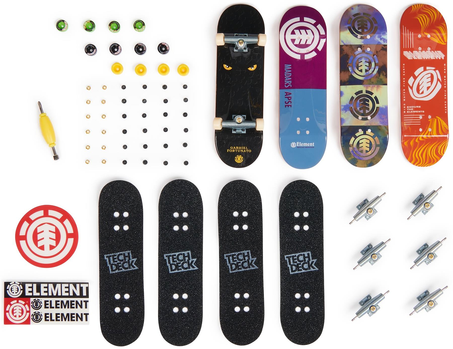 A flat lay of the Tech Deck M01 Deluxe 4 Pack Fingerboards - Element shows four mini skateboards with authentic graphics, grip tapes, trucks, wheels, a tool, screws, and Element stickers—all arranged on a white background.