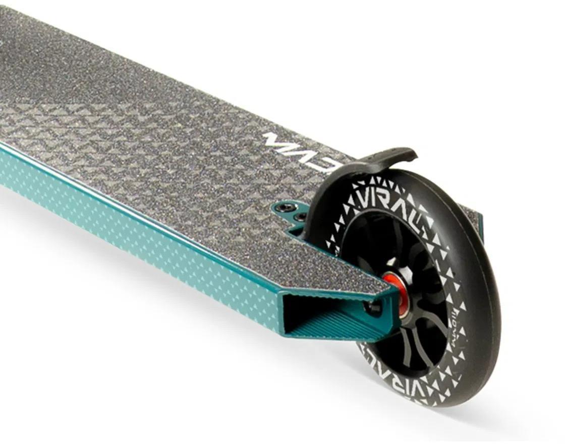 Close-up of the deck and rear wheel on the Madd Gear Viral KAOS Complete Stunt Scooter - Denim, showing its textured grip surface, black wheel with white graphics, and silver brake.