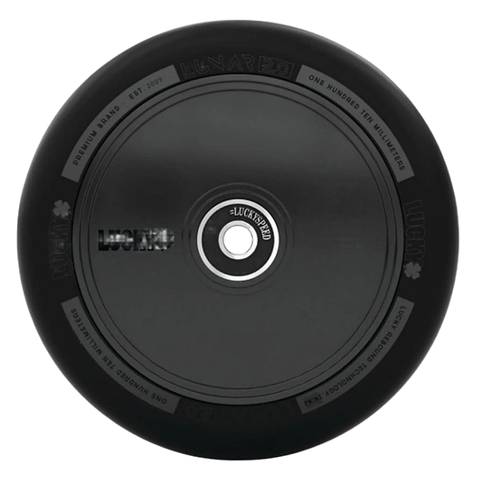 The Lucky Lunar 110mm Stunt Scooter Wheel - Shadow features a sleek black design with subtle decorations from above, showcasing "Lucky" branding and specs around its rim. Its circular metal core highlights the outstanding craftsmanship of Lucky Rebound Technology.