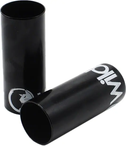 Two Wildcat Basic Steel Mini BMX Pegs in black, featuring white graphics, are shown on a white background—one standing upright and the other lying on its side. These chromoly pegs are designed for mounting on BMX axles.