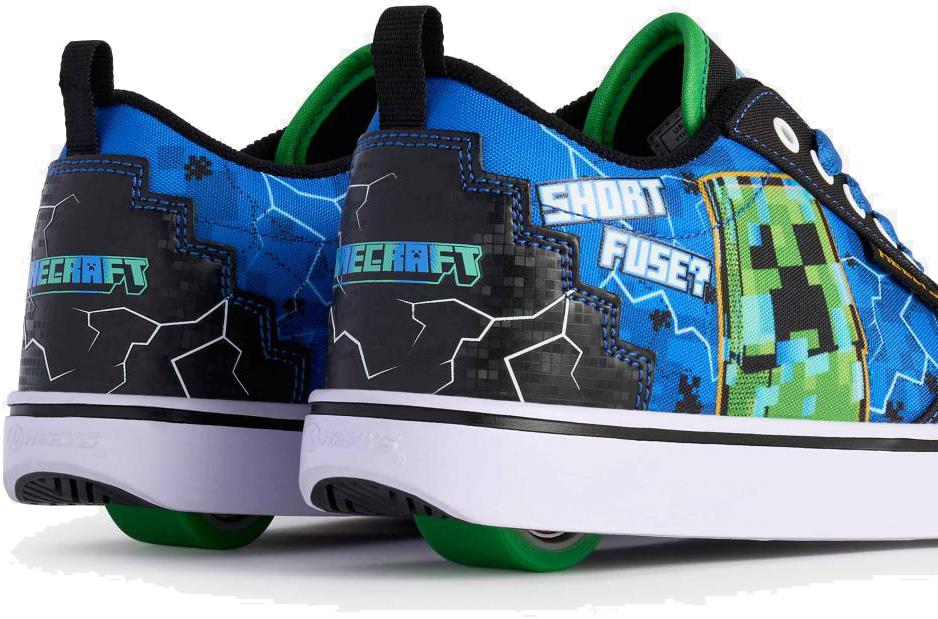 A close-up of the Heelys x Minecraft Pro 20 Boys Shoes by Heelys in black/blue/green, with a Creeper pixelated design, “SHORT FUSE?” text, and green wheels under the shoes.
