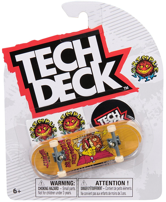 The Tech Deck 96mm M57 Fingerboard - Grimple Stix features a yellow deck with a cartoon monster graphic and "Grimple Stix" branding. Tech Deck logo and warning labels are displayed on the packaged collectible skateboard.