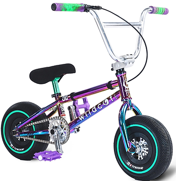 The Wildcat OG Pro Mini BMX Bike - Joker Green Neochrome features a metallic rainbow frame, thick black tires with teal rims, silver handlebars with green and purple grips, and purple pedals, shown from a front-side angle.