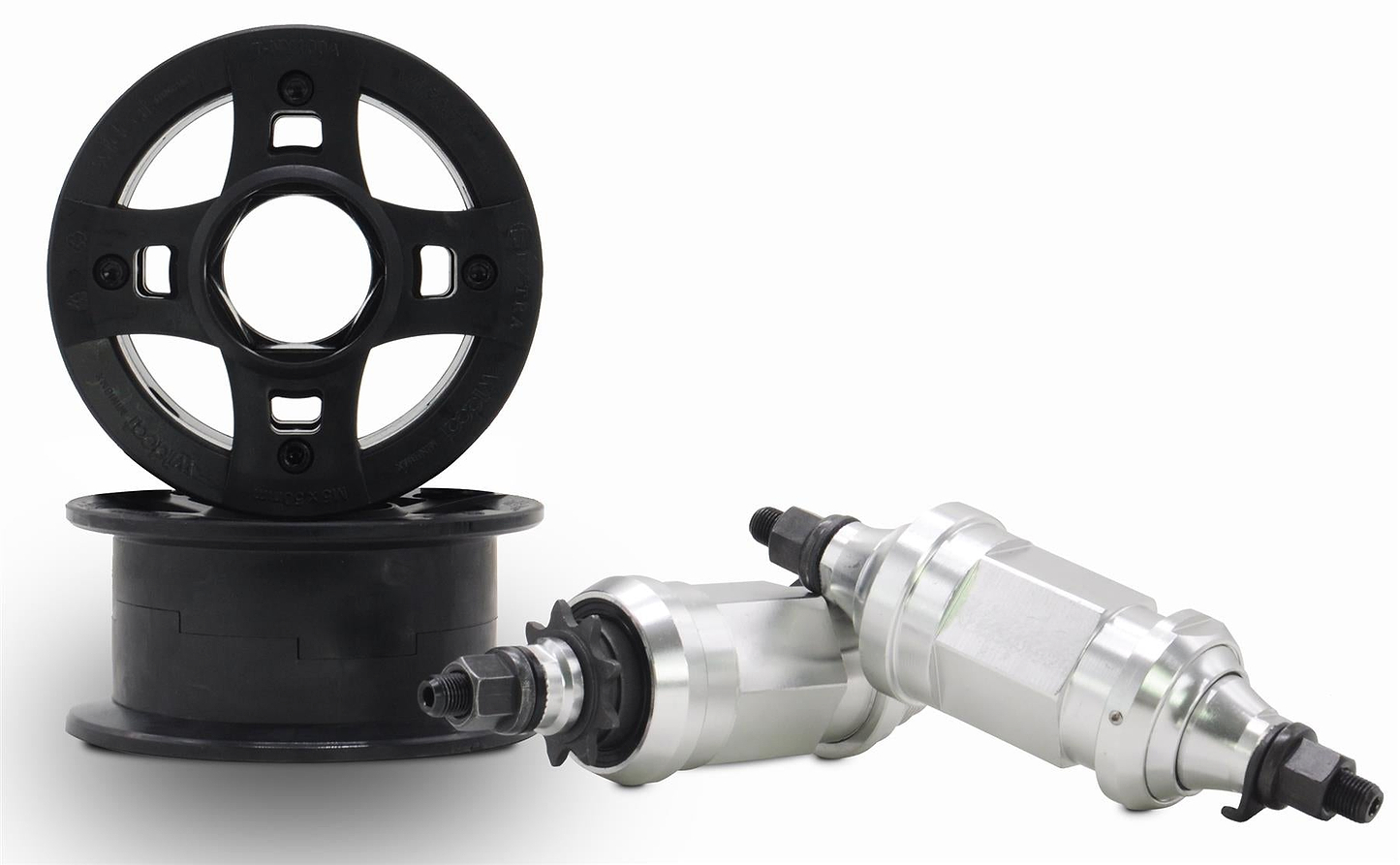 Two black plastic wheels with CNC aluminum rims and silver hubs with black axle bolts, made by Wildcat for the Wildcat OG 3A Mini BMX Bike - Royal Blue, are displayed on a white background—ideal replacement parts.