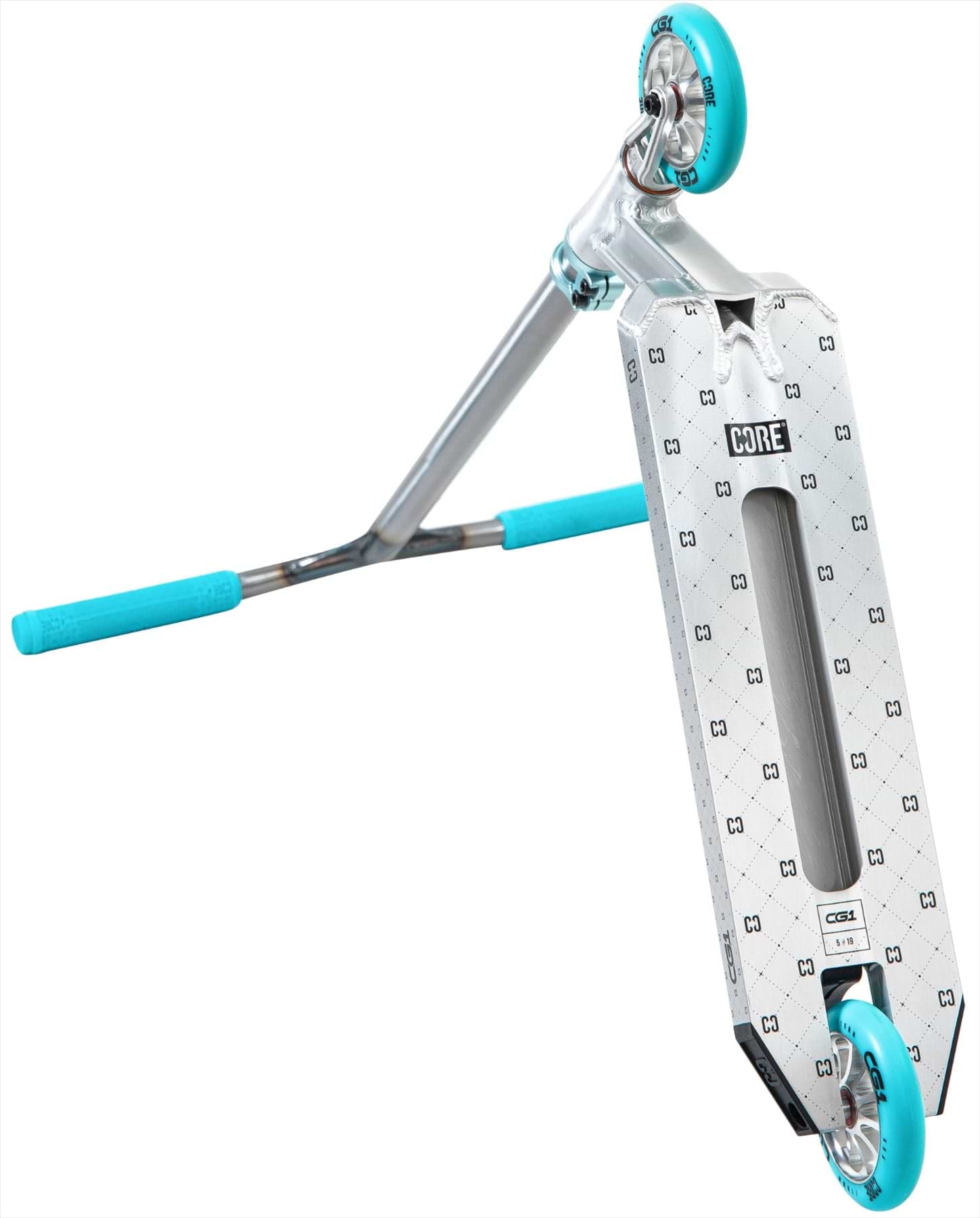 The CORE CG1 Complete Stunt Scooter in Raw/Teal is shown at an angle, featuring blue handle grips and wheels. The patterned deck displays the "CORE" branding, with the scooter tilted to highlight its underside and wheels.