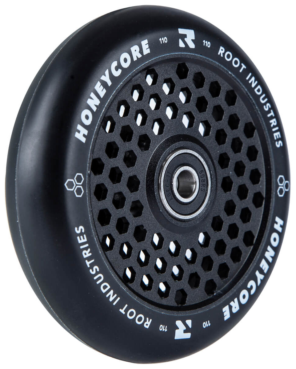 The Root Industries Honeycore 110mm Stunt Scooter Wheel in black features a honeycomb-patterned core and white branding, ideal for riders seeking lightweight performance. Shown on a white background.