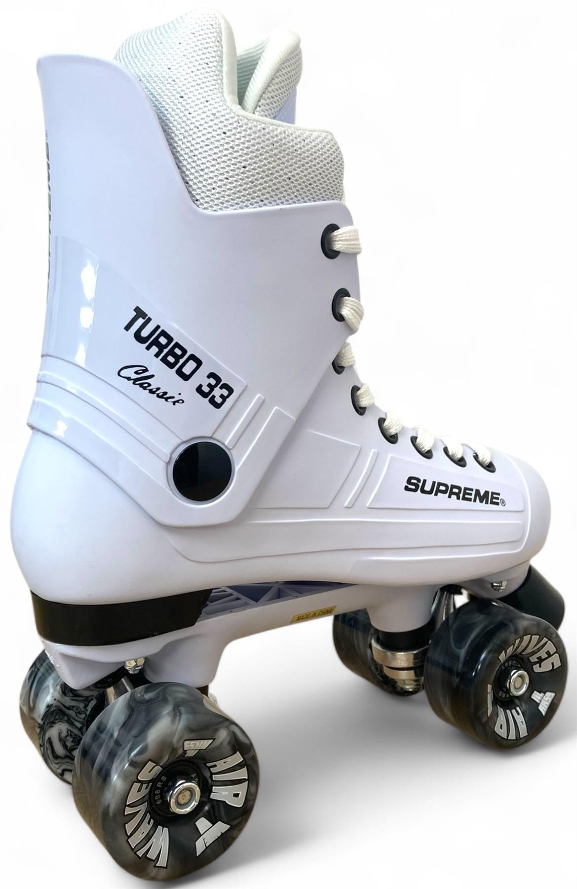The Supreme Turbo 33 Nylon Quad Roller Skates in white feature black swirl wheels, white laces, and black Supreme branding on the side, shown against a plain background.
