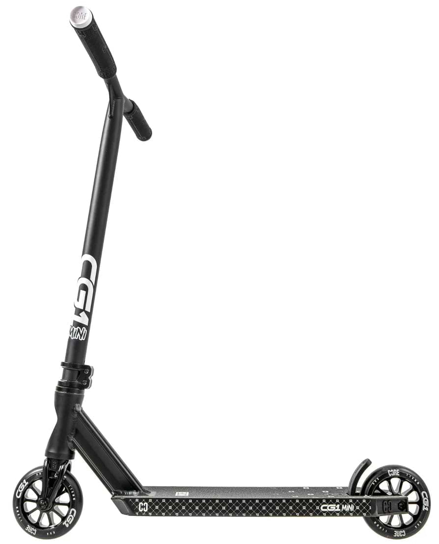 The CORE CG1 Mini Complete Stunt Scooter for kids features a black design with white "CORE" branding on the handlebars, small solid wheels, and a textured foot deck, shown side-on against a white background.