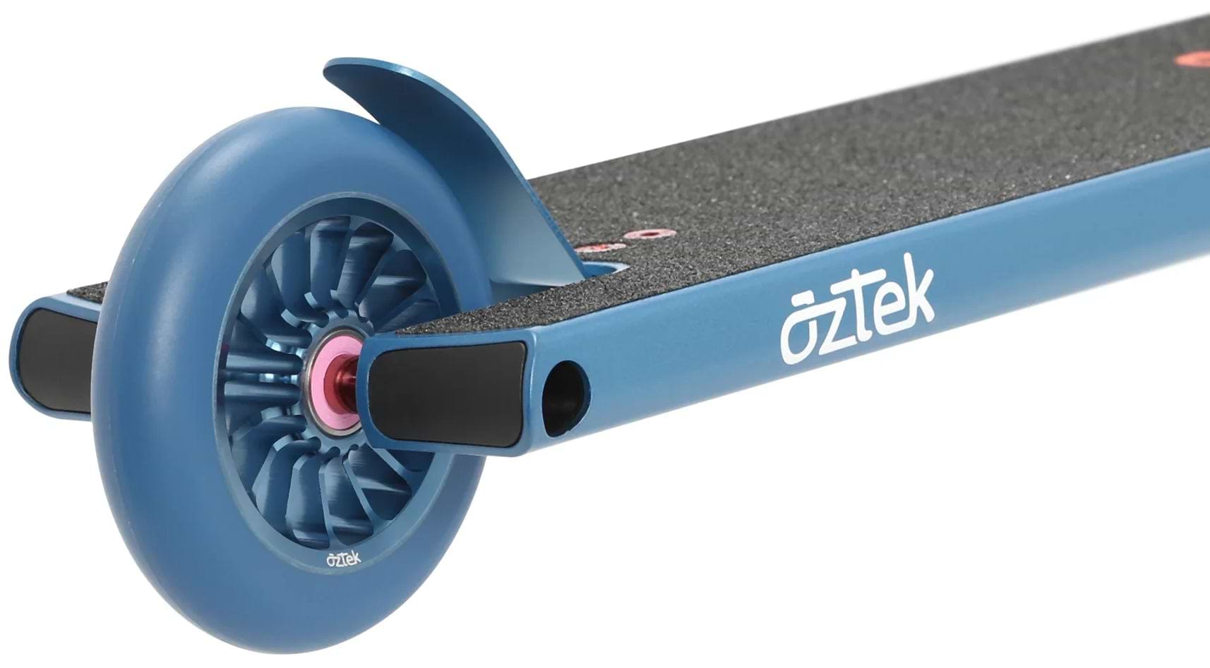 Close-up of the rear wheel and deck of an Aztek Architect 2 Complete Stunt Scooter in Neptune Blue, featuring textured black grip tape and the white "Aztek" brand name on the side.