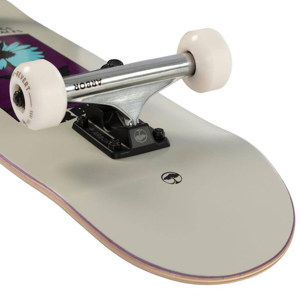 Close-up of Arbor Street Revert Daisy Mini Complete Skateboard - 7.5″ x 28.5″ truck and wheels on a white, sustainable Canadian maple deck with a small black logo and partial floral graphic.