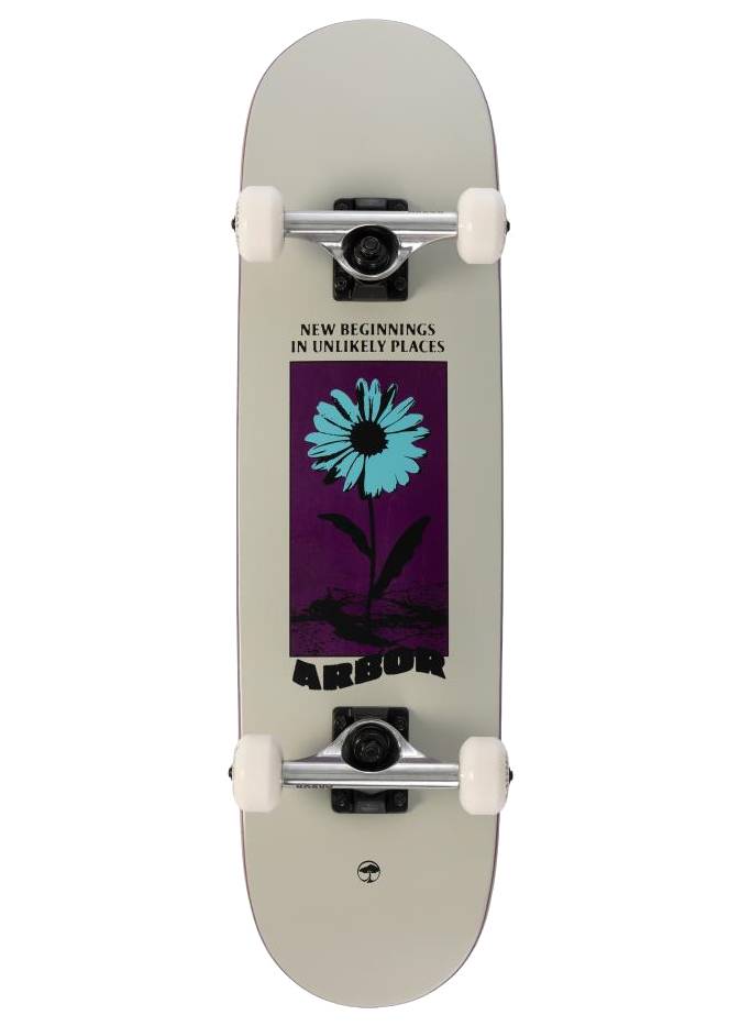 The Arbor Street Revert Daisy Mini Complete Skateboard - 7.5″ x 28.5″ features white wheels and a blue daisy graphic on purple with “NEW BEGINNINGS IN UNLIKELY PLACES” above and “ARBOR” below, made of sustainable maple.