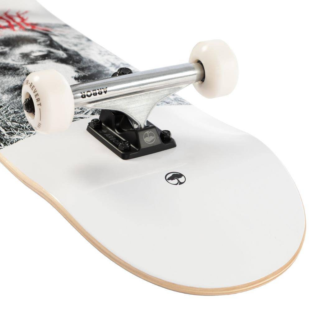 Close-up of the Arbor Street Revert Puppy Complete Skateboard - 8.25″ x 32″ with white wheels, metal trucks, and a white Canadian maple deck with black logo and grayscale/red graphics—perfect for park or street skating.