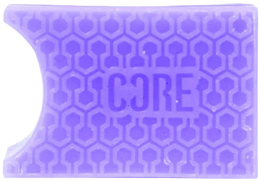 A rectangular blackcurrant purple grip with a honeycomb pattern and "CORE" embossed in the center, inspired by CORE Epic Skate Wax – Blackcurrant Purple, featuring a curved notch on the top left for skate wax fans.