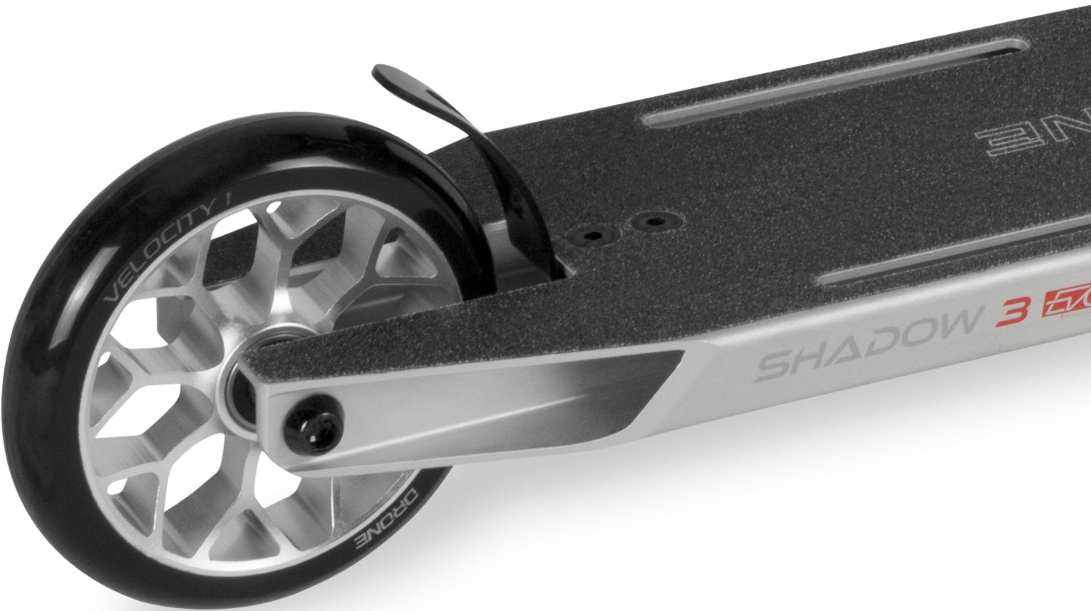 Close-up of a silver Drone Shadow 3 Evo Complete Stunt Scooter deck and rear wheel, highlighting the brake and grip tape.