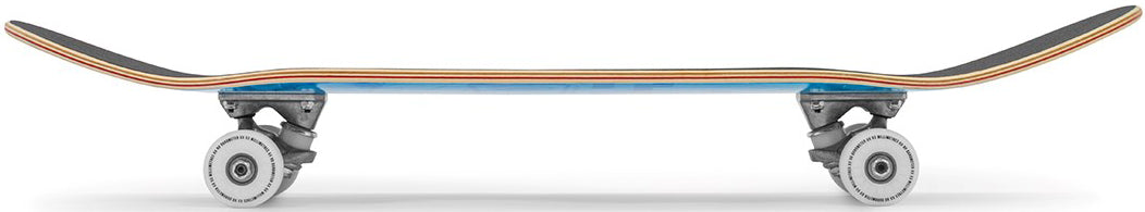 Side view of an Enuff Skully Blue Complete Skateboard - 7.75″ x 31.5″ featuring a blue deck and grey trucks.