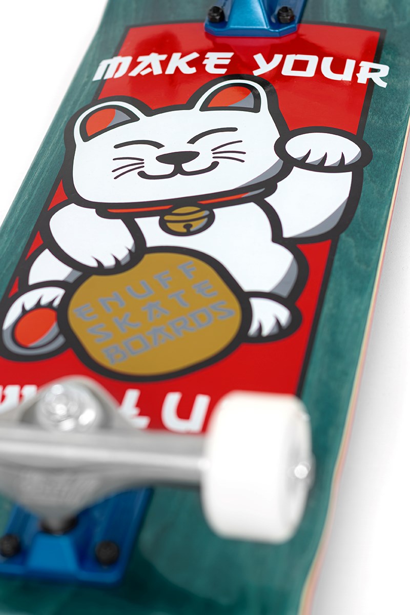 Close-up of the Enuff Lucky Cat Green Complete Skateboard - 8″ x 32″, a beginner board featuring a lucky cat graphic holding a gold coin reading “SNUFF SKATE BOARDS.” The top displays “MAKE YOUR,” with wheels and trucks visible at the bottom, making it perfect for street and park skating.