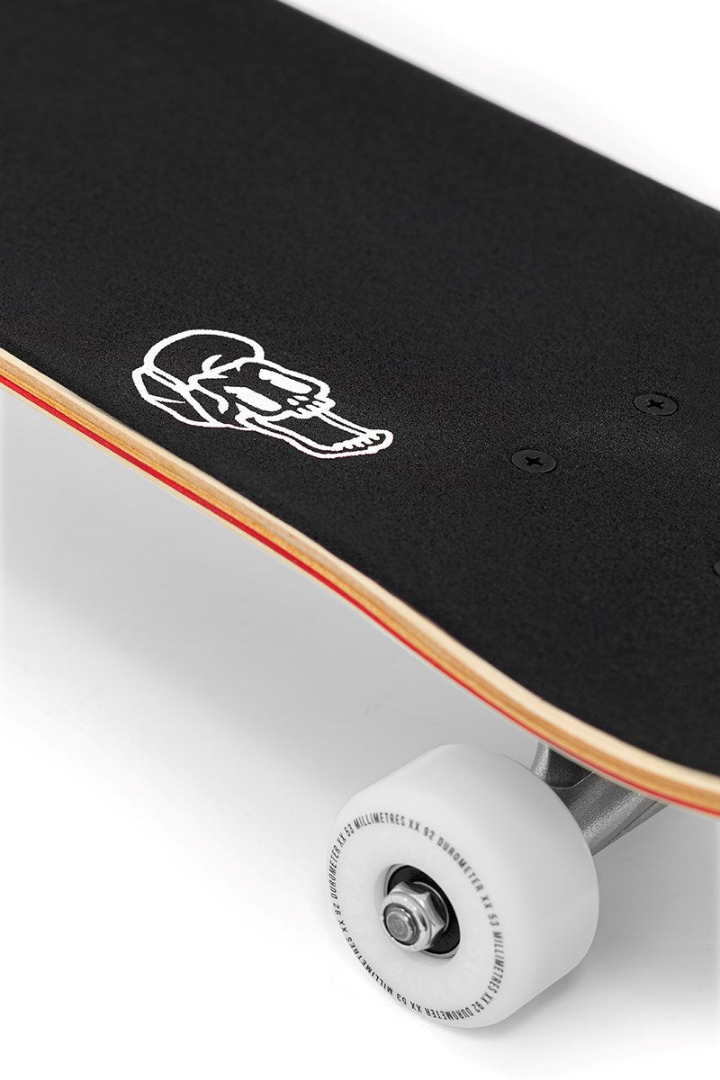 Close-up of the Enuff Lucky Cat Green Complete Skateboard – 8″ x 32″, a beginner-friendly deck with black grip tape and a bold white cat graphic. Ideal for street and park skating, this Enuff skateboard comes complete with white wheels, silver trucks, and visible layered wood along the deck edges.