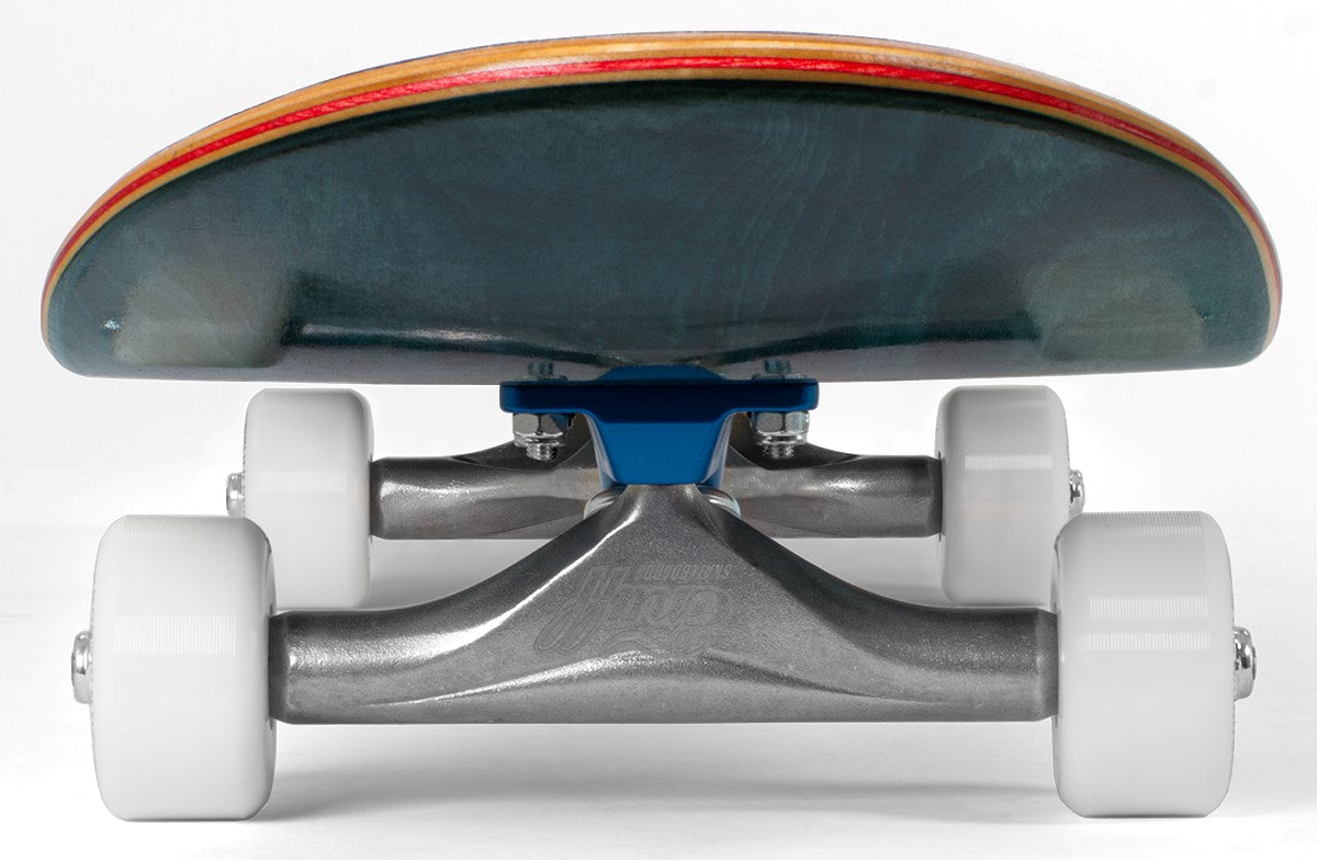 Close-up, low-angle view of the Enuff Lucky Cat Green Complete Skateboard - 8″ x 32″, captured from the front to highlight its white wheels, metal trucks with a blue baseplate, and layered wooden deck. This Enuff skateboard is ideal for street and park skating or as a beginner board, standing out beautifully against a plain white background.
