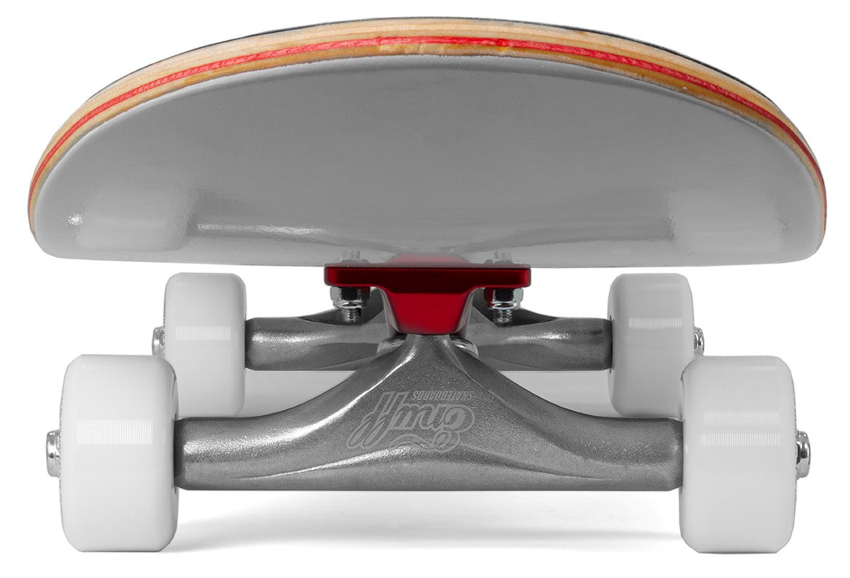 Close-up view from the ground of the Enuff Lucky Cat White Complete Skateboard’s underside, featuring white wheels, silver trucks with a red baseplate, and an 8″ x 32″ layered wooden deck—perfect for street and park skating.