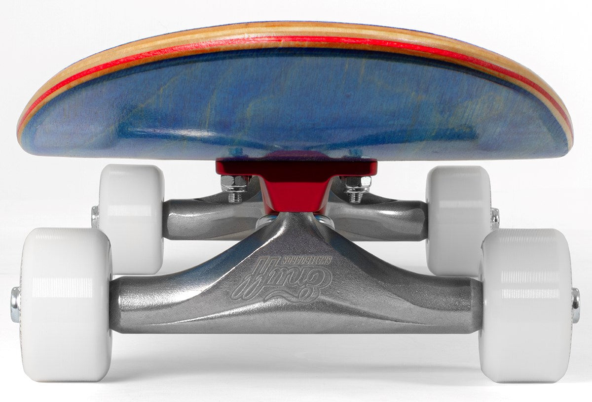 Close-up view of the Enuff Lucky Cat Mini Blue Complete Skateboard (7.25″ x 29.5″) from the front, featuring white wheels, silver trucks with a red baseplate, and a blue wooden deck with a natural wood edge. Set against a plain white background, this mini skateboard for kids by Enuff stands out in sharp detail.
