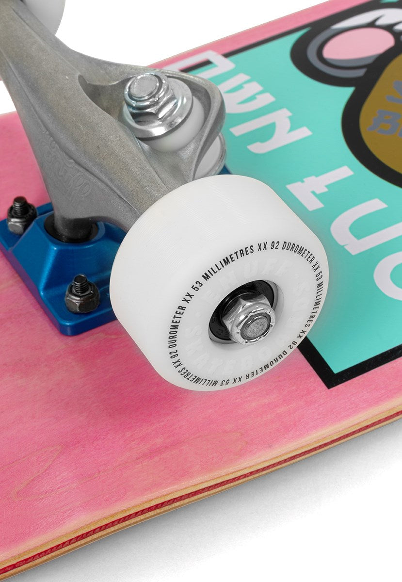 Close-up of a skateboard wheel attached to the truck on the Enuff Lucky Cat Mini Pink Complete Skateboard – 7.25″ x 29.5″, featuring a vibrant graphic on its pink deck and partial white text—ideal for kids or anyone choosing their first beginner board from Enuff.