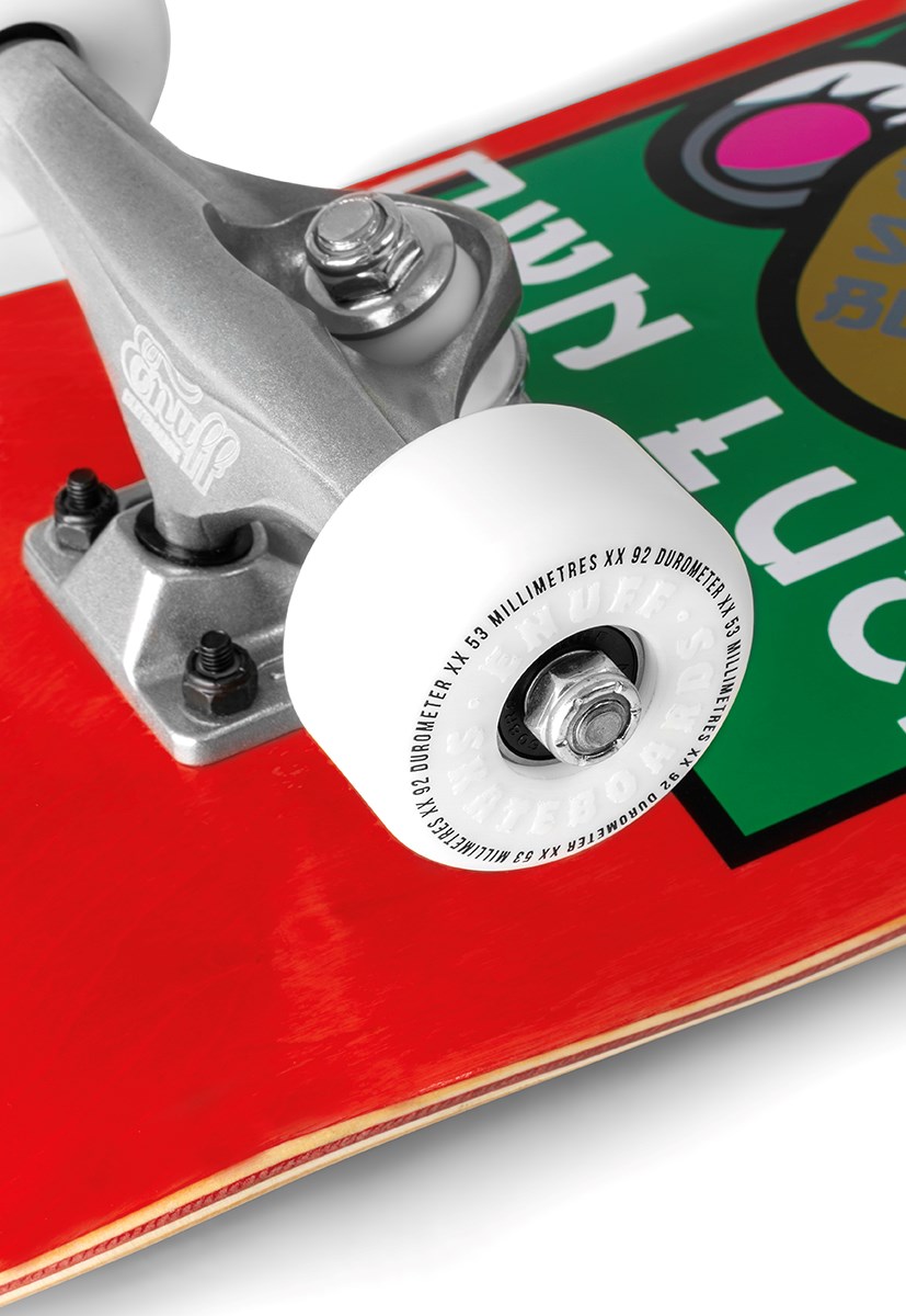 Close-up of the Enuff Lucky Cat Mini Red Complete Skateboard (7.25" x 29.5”) by Enuff, showing its white wheel, silver truck on a bright red deck, and part of its colorful graphic—ideal for kids or beginner skaters.