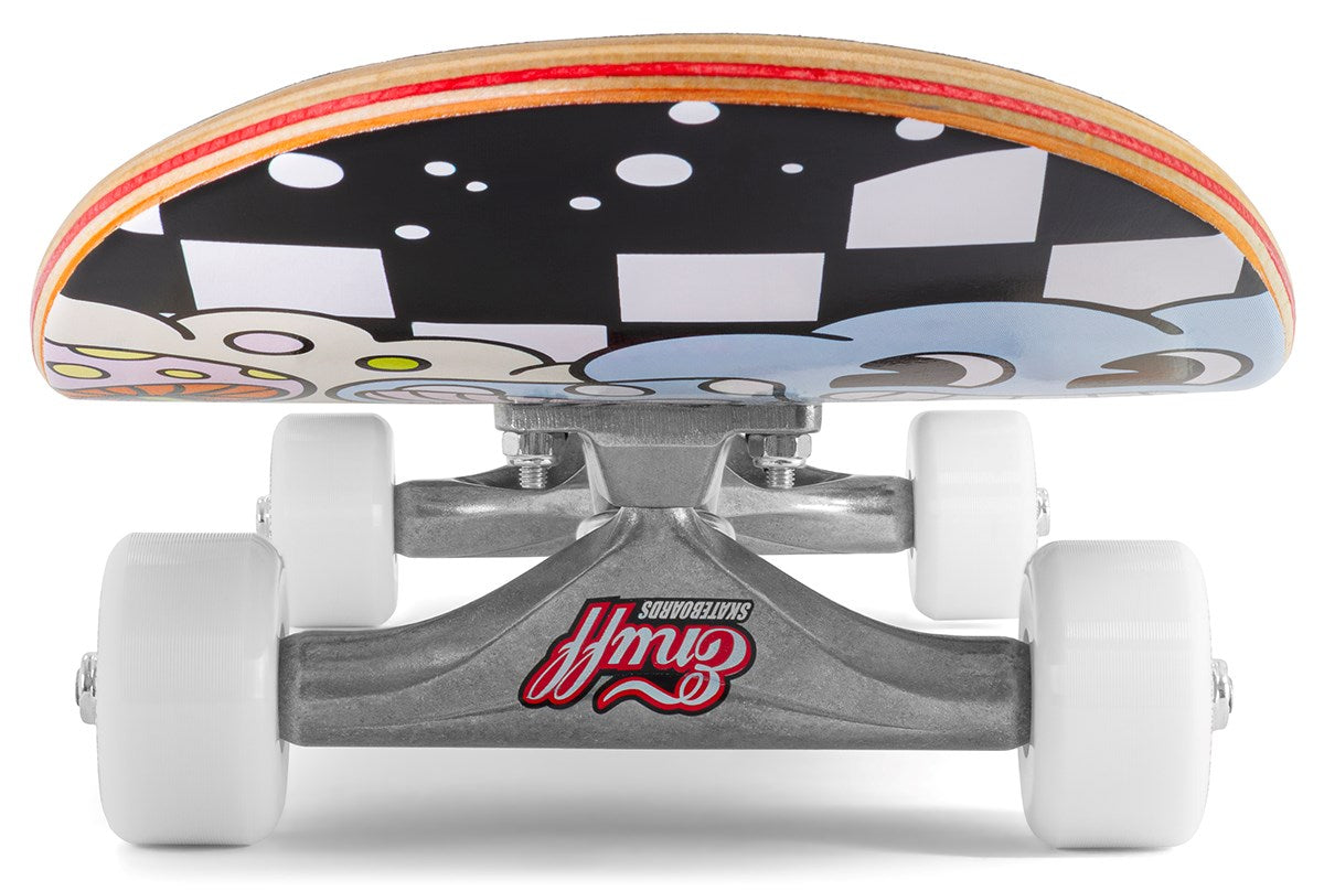 A ground-level close-up of the Enuff Meltworld Dazed Complete Skateboard (7.75" x 31.5") displays white wheels, Gullwing trucks, and a maple deck with bold black, white, and blue graphics—perfect for beginner riders.