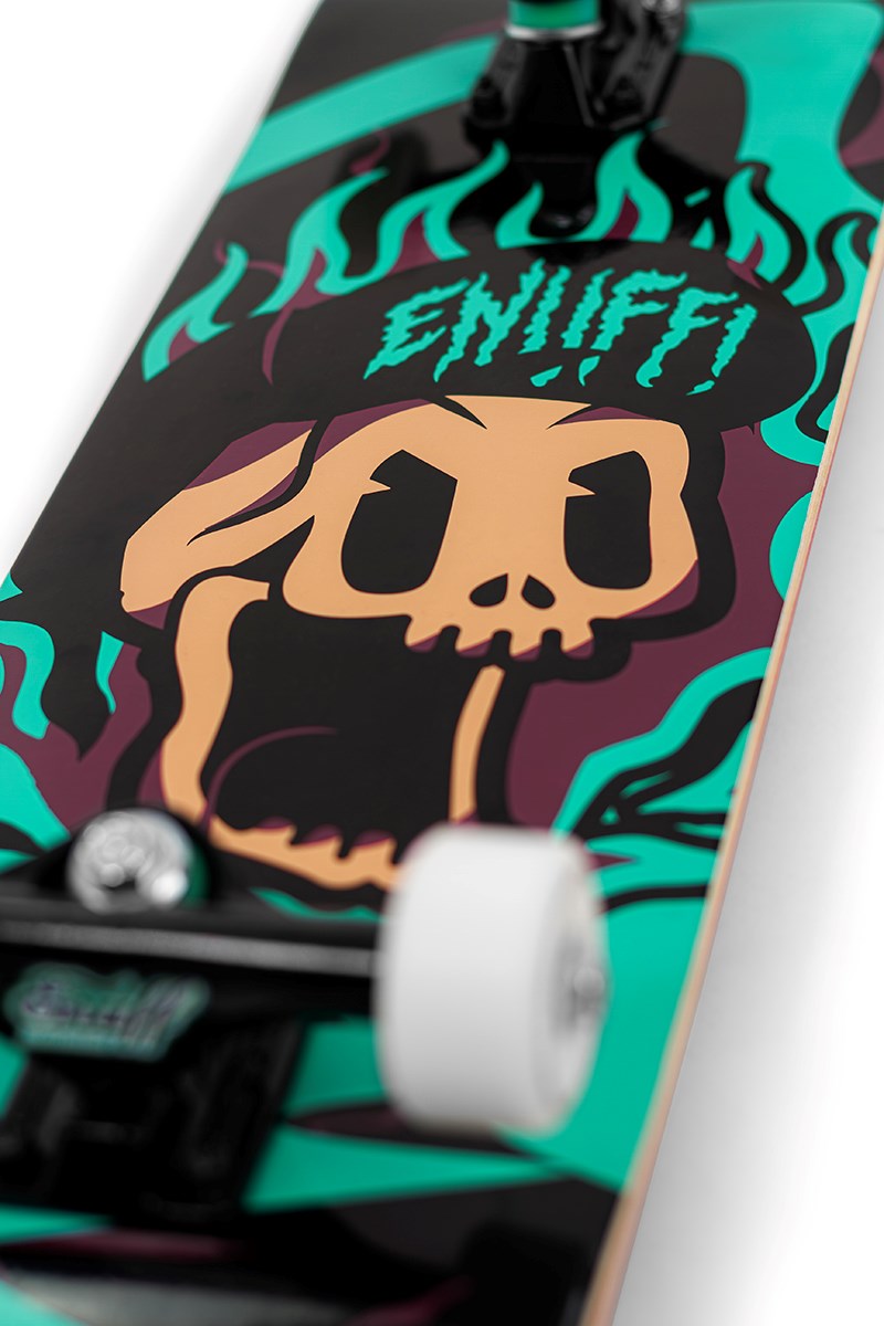 Close-up of the Enuff Pyro III Blue Complete Skateboard (7.75" x 31.5") showing bold, colorful skull-and-flame graphics with "ENIFFI" lettering, plus visible wheels and trucks by Enuff.