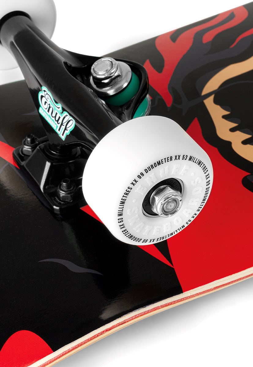 Close-up of the Enuff Pyro III Red Complete Skateboard by Enuff, sized 7.75" x 31.5", featuring bold red and black graphics on a 7-ply maple deck, white wheels, and black trucks with a green Enuff logo.
