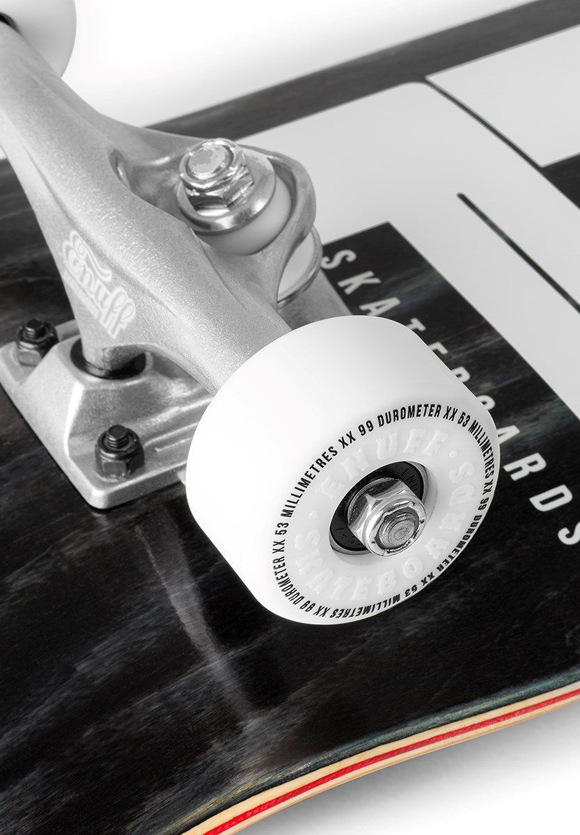 Close-up of the Enuff Throwback Black Complete Skateboard - 8.5" x 32.1" by Enuff, showing the detailed text and texture on the white wheel and metal parts of its 7-ply maple deck.