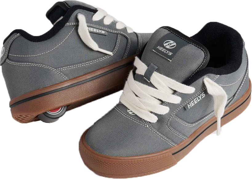 A pair of Heelys Pro 25 Boys Shoes in grey, antique white, and black by Heelys; one shoe features a visible wheel in the heel.