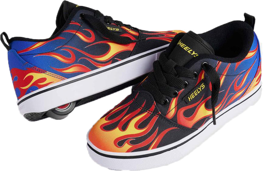 A pair of Heelys Pro 20 Prints Boys Shoes by Heelys, featuring black laces and vibrant flame designs in red, orange, and yellow on a blue background, with a visible single wheel in the sole of one shoe.
