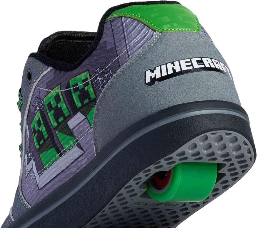 A close-up of the Heelys x Minecraft Pro 25 Prints Boys Shoes - Grey / Green shows green Creeper graphics, “MINECRAFT” text on the heel, and a green wheel in the sole—ideal for boys.