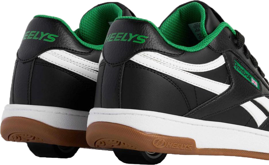 The Heelys x Reebok Classic Boys Shoes - Black / White / Gum feature white stripes, green inner lining, gum soles, and a visible wheel in each heel for a retro-inspired look.