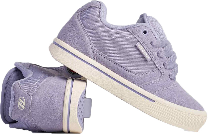 A pair of Heelys Pro 25 Girls Shoes - Purple / Cream, one upright and one on its side, display textured fabric, laces, a rubber sole, and a white stripe around the base.