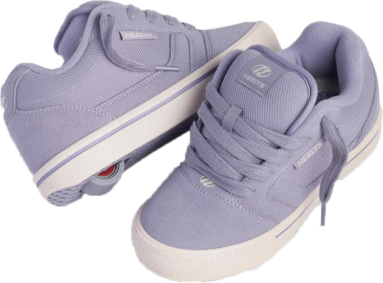 A pair of Heelys Pro 25 Girls Shoes - Purple / Cream by Heelys, with one shoe displaying the wheel in the heel and the other showing off the laces, logo, and classic wheeled sneaker look.
