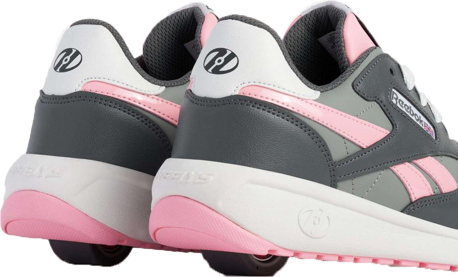 The Heelys x Reebok Classic Girls Shoes - Grey / Pink / White feature pink soles, black wheels in the heels, and combine classic sneaker style with fun roller shoe functionality.