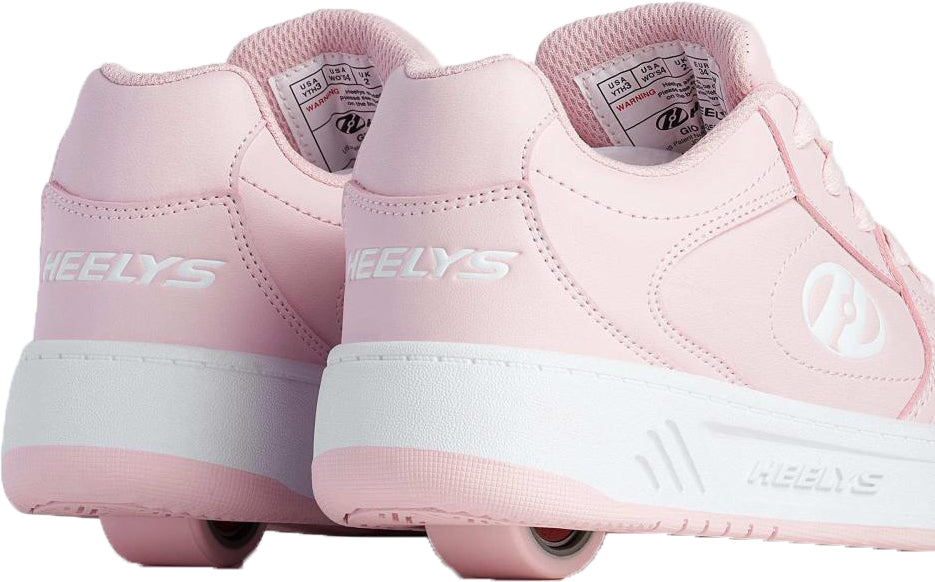 Pair of light pink and white Heelys Gio Girls Shoes - Frost Pink / White court-style sneakers, each featuring a single wheel integrated into the heel.
