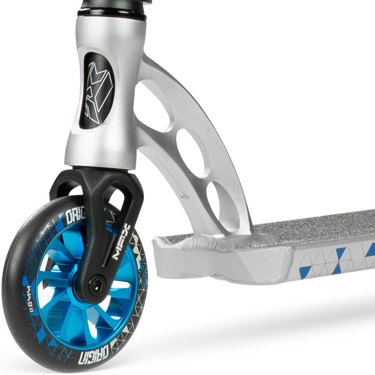 Close-up of the Madd Gear (MGP) VX Origin IV 500 Complete Stunt Scooter - Scalene, showing a metallic blue wheel, silver fork with cut-out holes, and a textured deck with blue and grey triangular patterns.