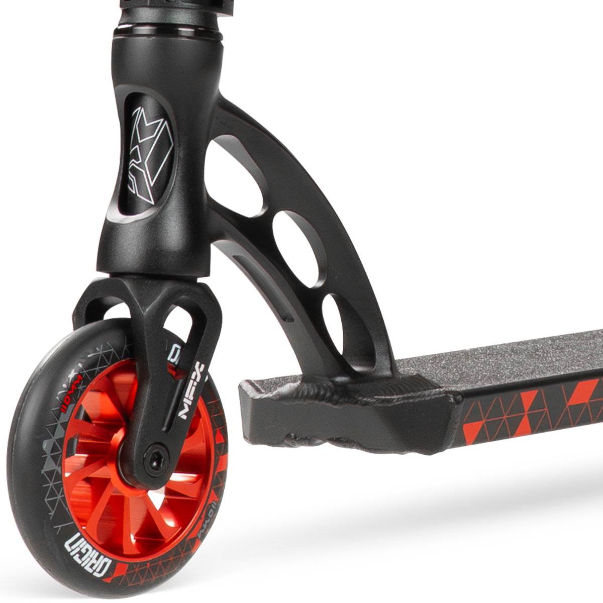 Close-up of the Madd Gear (MGP) VX Origin IV 500 Complete Stunt Scooter - Trigon, highlighting its red wheel with black and white graphics, black fork, and a deck featuring geometric red and black designs.