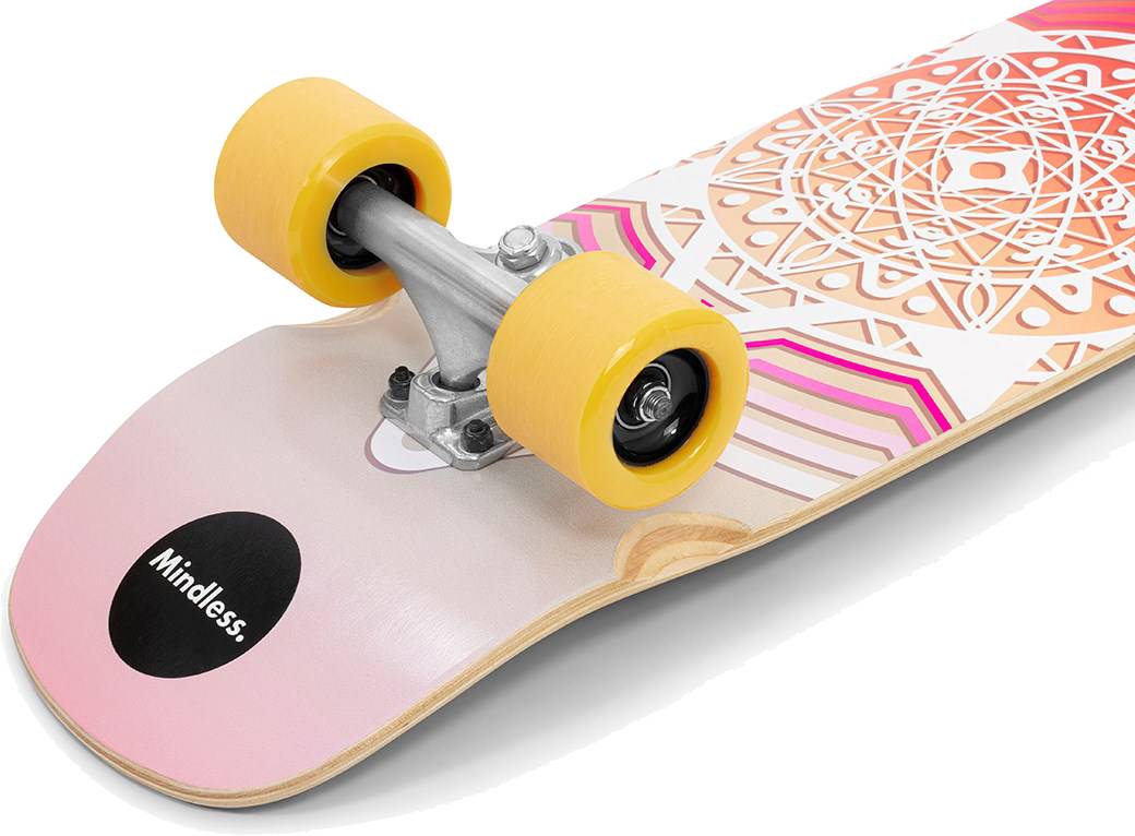 Close-up of a Mindless Drifter Cruiser Skateboard 28″ x 8″ - Orange with yellow wheels, silver trucks, and a colorful geometric pattern. “Mindless” appears on a black circle near the edge of this urban cruiser.