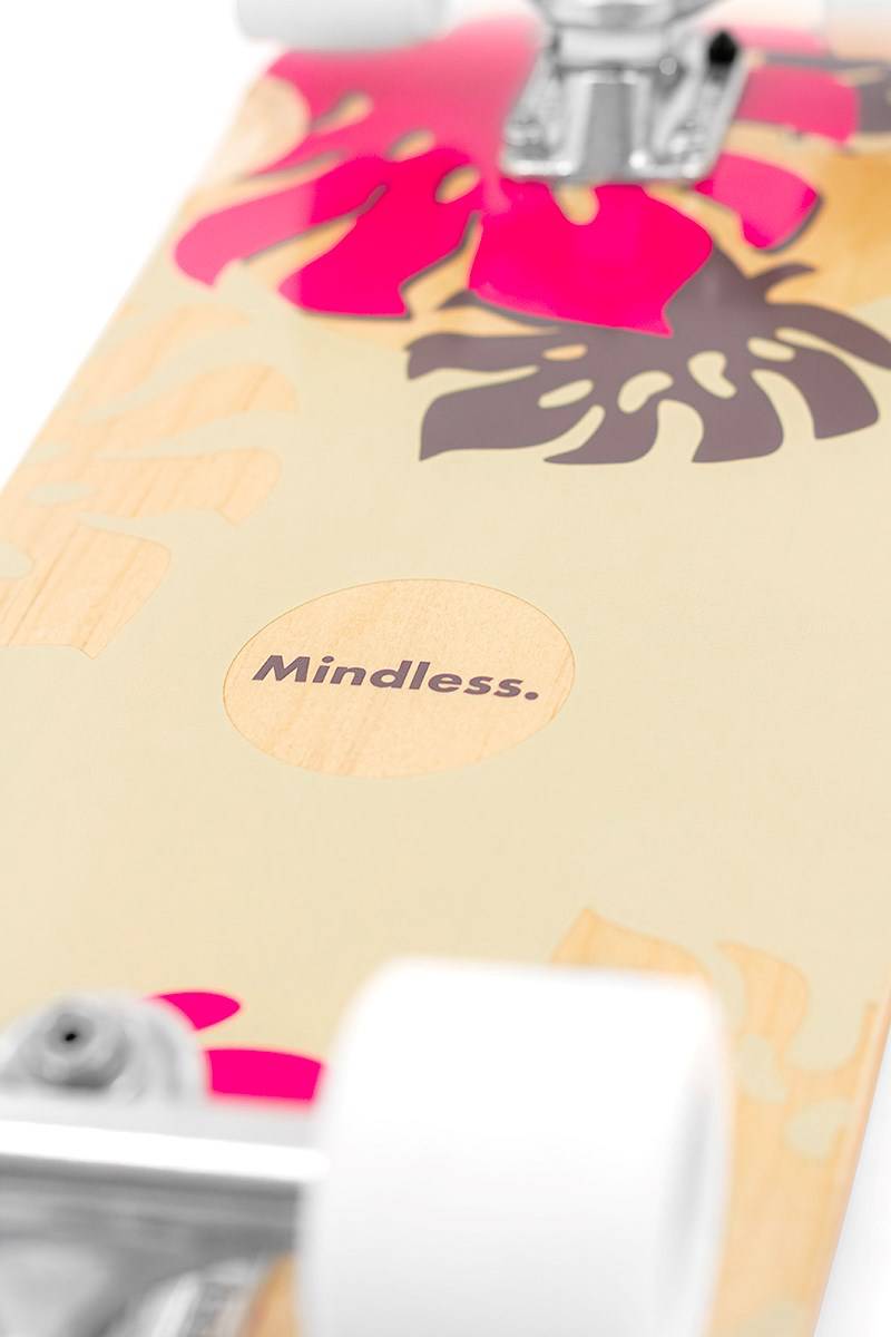 Close-up of the Mindless Oasis Cruiser Skateboard 32″ x 9″ - Natural, featuring pink and dark brown tropical leaf graphics, white wheels, and premium ABEC 9 Chrome bearings.