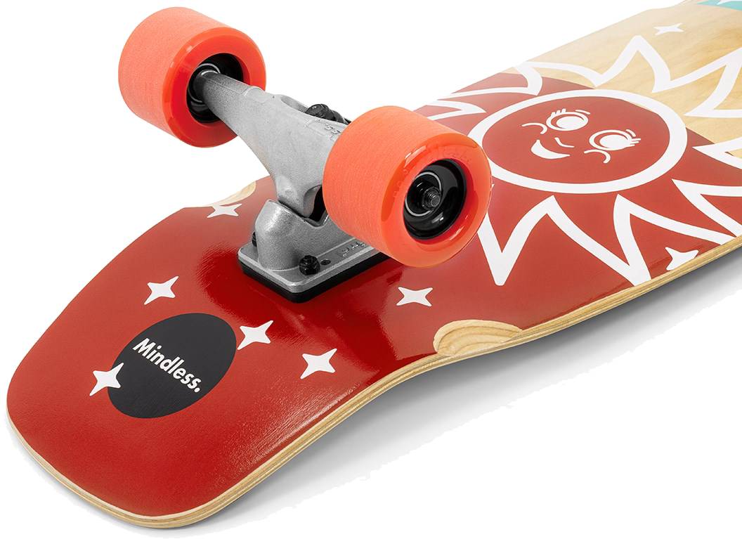 Close-up of the Mindless Soul Surf Skate Cruiser Skateboard 29.5″ x 9.75″ - Red with a smiling red sun, orange wheels, silver trucks, white stars, and “Mindless” printed on the deck.